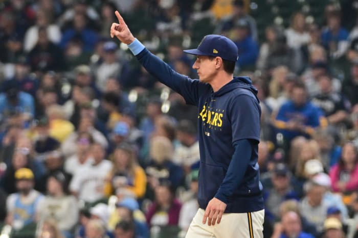 Craig Counsell puts one finger up to the sky
